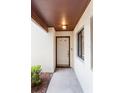 Front entrance featuring a well-lit, covered porch and neutral-colored exterior at 101 Grand Plaza Dr # P6, Orange City, FL 32763
