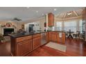 View of kitchen with wooden cabinets, granite countertops, stainless steel appliances and hardwood floors at 104 Forest Point Ln, Longwood, FL 32779