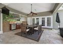 Covered outdoor dining area with built-in grill, television and ceiling fan at 104 Forest Point Ln, Longwood, FL 32779