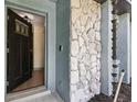 Open entryway featuring a modern door, stone accents, and a glimpse into the bright, inviting interior at 1360 Gladiolas Dr, Winter Park, FL 32792