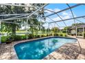 Inviting screened-in pool with a scenic view of the lake and backyard at 14377 Lord Barclay Dr, Orlando, FL 32837