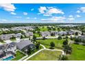 Wide aerial perspective of the neighborhood highlighting community green spaces and nearby homes at 14880 Ellingsworth Ln, Winter Garden, FL 34787