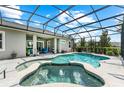 Relaxing screened-in pool and spa with a covered patio and outdoor seating at 14880 Ellingsworth Ln, Winter Garden, FL 34787