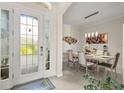 Elegant foyer featuring double glass doors, tile flooring, and a view into the dining area at 16108 Bristol Lake Cir, Orlando, FL 32828