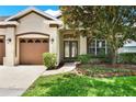Charming home showcasing a beautifully landscaped front yard, complemented by a welcoming entrance at 1657 Tennyson Ct, Lake Mary, FL 32746