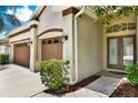 Inviting home exterior highlighting a three-car garage and a covered front entry at 1657 Tennyson Ct, Lake Mary, FL 32746