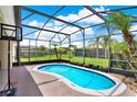Enjoy this screened-in pool area with a tropical view, perfect for relaxing and entertaining at 1657 Tennyson Ct, Lake Mary, FL 32746