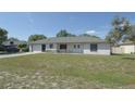 Classic single-story home featuring a well-maintained lawn and attached one car garage at 1668 Fort Smith Blvd, Deltona, FL 32725