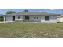Inviting single-story home with manicured front lawn and attached one car garage at 1668 Fort Smith Blvd, Deltona, FL 32725