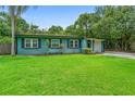 Charming home with a well-manicured lawn, vibrant foliage, and inviting curb appeal at 1805 Paloma Ave, Sanford, FL 32771
