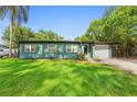 Welcoming home featuring a freshly painted exterior, an attached garage, and lush green lawn at 1805 Paloma Ave, Sanford, FL 32771
