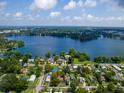 Stunning aerial view of the property with lake access, surrounded by mature trees and neighboring homes at 1979 Staunton Ave, Winter Park, FL 32789