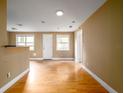 Spacious living room boasts wood floors, natural light, and neutral colors, offering a versatile space at 1979 Staunton Ave, Winter Park, FL 32789