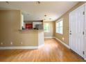 Bright living room showcasing hardwood floors, white door, and convenient breakfast bar at 1979 Staunton Ave, Winter Park, FL 32789