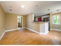 Open living area featuring wood floors, a breakfast bar, white cabinets and stainless-steel appliances at 1979 Staunton Ave, Winter Park, FL 32789
