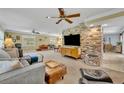 Spacious and brightly lit living room with plush seating, exposed brick, and neutral decor at 2081 Mohican Trl, Maitland, FL 32751