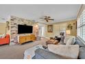 Cozy living room with exposed brick, plush seating, ceiling fan, and neutral decor at 2081 Mohican Trl, Maitland, FL 32751