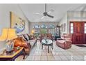 Comfortable living room with tile floors, ample seating, large windows, and a decorative ceiling fan at 2209 Fairglenn Way, Winter Park, FL 32792