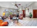 Bright living area with tile floors, ceiling fan, arched windows, and elegant furnishings at 2209 Fairglenn Way, Winter Park, FL 32792