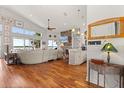 Spacious living room featuring hardwood floors and expansive windows with waterfront views at 291 River Rd, Oak Hill, FL 32759