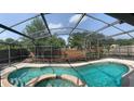 Inviting screened-in pool and spa surrounded by lush landscaping, perfect for relaxation and outdoor enjoyment at 3055 Dellcrest Pl, Lake Mary, FL 32746