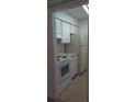 Efficient kitchen featuring white appliances and ample cabinetry at 315 Wymore Rd # 104, Altamonte Springs, FL 32714