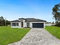 Beautiful single-story home with a well-kept lawn and dark grey brick driveway that enhances curb appeal at 3420 Sw 130Th Lane Rd, Ocala, FL 34473