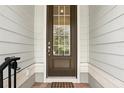 Inviting front door with glass pane, and brick pavers creates a warm and welcoming entrance at 439 Windmill Palm Cir, Altamonte Springs, FL 32701