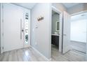 Modern entryway with white door, sleek hardware, and a view into the powder room showcasing the home's contemporary design at 4414 Le Reve Ct, Kissimmee, FL 34746