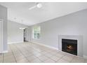 Spacious living area with fireplace, tile floors, and ceiling fan, perfect for relaxation at 4870 S Semoran Blvd # 1905, Orlando, FL 32822