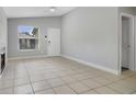 Bright living room showcasing neutral paint, tile floors, and a charming fireplace at 4870 S Semoran Blvd # 1905, Orlando, FL 32822