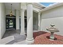 Grand entrance featuring stately columns, decorative fountain, and tiled walkway leading to the inviting front door at 5453 Grove Mnr, Lady Lake, FL 32159