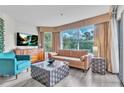 Cozy living room featuring stylish furniture, modern flooring, and large bright windows at 6337 Parc Corniche Dr # 2312, Orlando, FL 32821