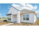 Side view of a modern white home with a gray roof and neutral trim at 6723 Sherpa Trl, St Cloud, FL 34771