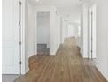 Bright hallway featuring beautiful wood-look flooring and white doors leading to other rooms at 6723 Sherpa Trl, St Cloud, FL 34771