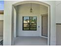 Welcoming front porch with a covered entrance and modern light fixture at 921 Costa Mesa Ln, Kissimmee, FL 34744