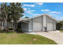 Attractive single-story home with a well-manicured lawn and an attached two-car garage on a sunny day at 10438 Sw 85Th Ct, Ocala, FL 34481
