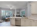 Open kitchen featuring stainless steel appliances and granite countertops that flows into the living area at 1124 Hidden Blf, Clermont, FL 34711