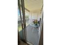 Cozy balcony with a small table, chairs, and outdoor views at 11582 Westwood Blvd # 1428, Orlando, FL 32821