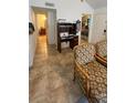 Inviting living room with tiled floors, comfortable seating, and a view of the bedroom and bathroom at 11582 Westwood Blvd # 1428, Orlando, FL 32821