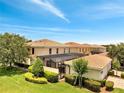 Aerial view of townhomes featuring tile roofs, screened-in patios, and well-manicured green spaces at 11937 Bianca Ln, Orlando, FL 32827