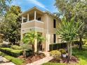 Well-maintained two-story home with a balcony, complemented by lush landscaping and a brick walkway at 11937 Bianca Ln, Orlando, FL 32827