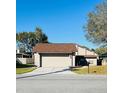 Inviting single-Gathering home featuring a two-car garage and manicured lawn at 1422 Spalding Rd, Winter Springs, FL 32708