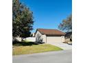 Exterior showing the side of the home with a driveway, lawn and tree at 1422 Spalding Rd, Winter Springs, FL 32708