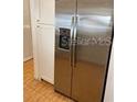 Stainless steel refrigerator with built-in ice maker and modern white cabinets at 1422 Spalding Rd, Winter Springs, FL 32708