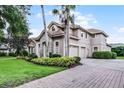Two-story home with stone accents, a two-car garage, and well-manicured landscaping at 1453 Langham Ter, Lake Mary, FL 32746