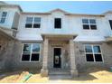 Unfinished townhome showing framing and windows with building wrap at 15382 Burgtheater Dr, Winter Garden, FL 34787