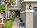 Home with a front porch and chairs, a walkway, and decorative trees at 1803 Meadow Pond Way, Orlando, FL 32824
