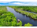 Magnificent aerial view of a wide river winding through a dense green forest at 20 Twelve Oaks Trl, Ormond Beach, FL 32174