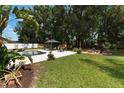 Expansive backyard featuring a luxurious pool, covered gazebo, and cozy fire pit area for ultimate relaxation and entertainment at 2122 Palm Crest Dr, Apopka, FL 32712